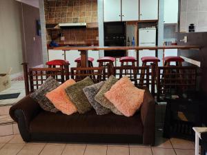 a couch with pillows on it in a kitchen at Sole Sands Bliss Guesthouse in Meer en See