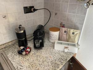 a kitchen counter with a coffee maker and a coffeemaker at Casa Matilde in Sestu +21 photos