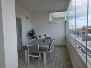 a dining room with a table and chairs on a balcony at Fiumicino Beach - Sleep & Fly in Focene