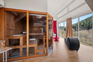 a room with a desk and a chair and windows at Luxus-Gästehaus mit Sauna, Kamin & exklusivem Paarbereich in Neubulach