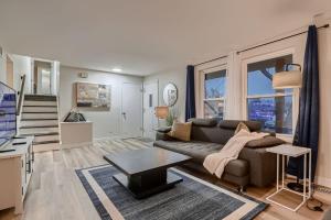 a living room with a couch and a table at The Arvada Retreat with HotTub, Games, Gym and Lounge in Arvada