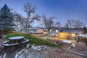 a backyard with a picnic table and a house at The Arvada Retreat with HotTub, Games, Gym and Lounge in Arvada