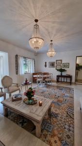 a living room with a wooden table and a living room at Leclerc Hotel Boutique Cali Granada in Cali