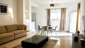 a living room with a couch and a table at Cozy One-Bedroom Apartment in Praia +36 photos