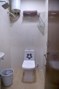 a small bathroom with a toilet and a sink at Yendluri's- QueenBed Room-17 Kondapur, Gachibowli in Lingampalli