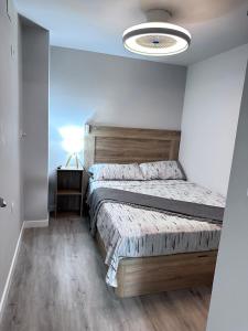 a bedroom with a large bed and a light at TAJ house center altea #1 in Altea