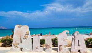 a sign on the beach in front of the ocean at TAJ house center altea #A in Altea