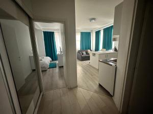 a room with a kitchen and a living room at AlyStar apartament in Mamaia Sat/Năvodari