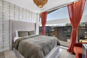 a bedroom with a bed and a large window at The Business Bungalow-5 Mins From Airport in Atlanta