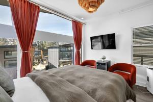 a bedroom with a bed and a large window at The Business Bungalow-5 Mins From Airport in Atlanta