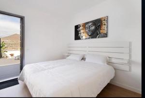 a white bedroom with a large bed and a window at Abades confort & luxury in Abades +21 photos