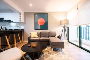 a living room with a couch and a table at Bohemian Barranco Apartments by Geko in Lima