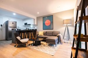 a living room with a couch and a table at Bohemian Barranco Apartments by Geko in Lima +16 photos