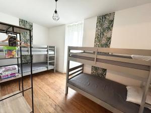 a room with three bunk beds in a room at Jolie maison familiale 14 personnes in Trélazé +124 photos