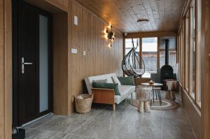 a living room with a couch and a table at Acasa la Pojorata in Pojorâta +80 photos