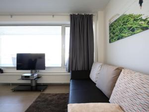 a living room with a couch and a flat screen tv at Wangerooge sea view Comfortable Vacation Home in Wangerooge