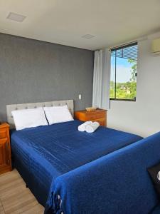 インビトゥバにあるHotel Backdoorの青いベッドと2枚のタオルが置かれた寝室 +57枚の写真