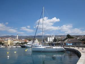 a sailboat is docked in a harbor with other boats at Apartments Skiljan in Crikvenica