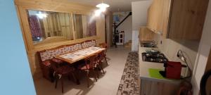 a kitchen with a table and chairs in a room at La Sosta1-2 in Arliod