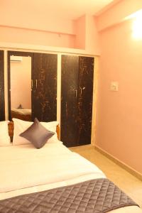 a bedroom with a bed and a large window at Fort Square Apartments - 101 in Vellore