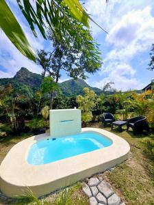 a swimming pool with a computer in a yard at Pika 02 by Pika cabins con Piscina privada in San Carlos +8 photos