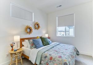 a bedroom with a bed and a table and a window at Stylish Pet Friendly Home for Work & Relaxation in American Fork