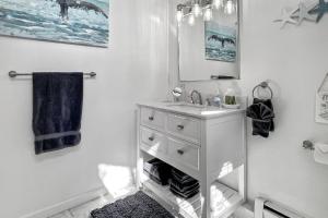a white bathroom with a sink and a mirror at Grove Place Beach West Haven in West Haven +43 photos