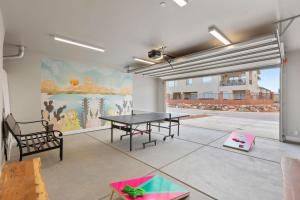 a ping pong table in a room with a mural at Luxury Poolside Retreats Near Zion l Private Pools in Hurricane