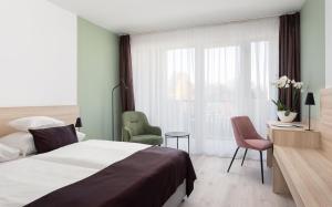 Postel nebo postele na pokoji v ubytování Hunguest Hotel Flóra