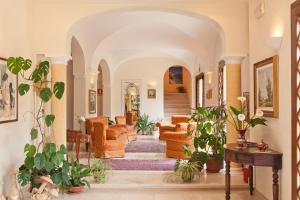 a living room filled with furniture and lots of plants at Torre Bennistra in Scopello