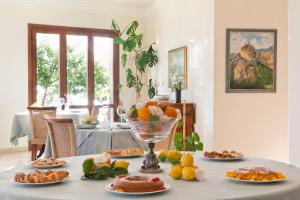 a table with a bunch of food on it at Torre Bennistra in Scopello