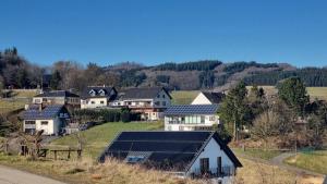 a group of houses with solar panels on their roofs at Ferienwohnung Zum Pflanzgarten in Herresbach