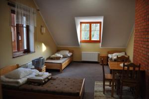 En eller flere senge i et værelse på Baza Noclegowa na Barbarce