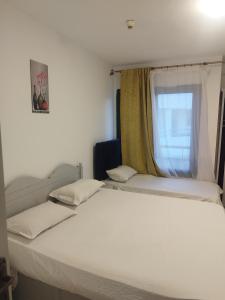 a bedroom with a large white bed with a window at bella vita- city center- criss resort in Sharm El Sheikh +49 photos