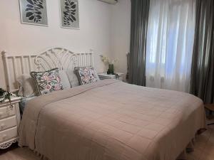 a bedroom with a large bed and a window at PARADISE GARDEN in Los Alcázares +56 photos