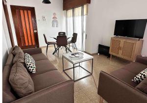 a living room with a couch and a table at Comfortable Engomi Apartment in Yukarı Lakatamya