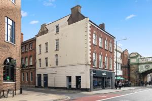 an old white building on the corner of a street at WhiskAwayHomes - Jenkins House - Studio 2 in Worcester