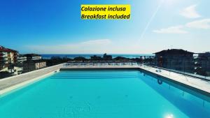 a swimming pool on the roof of a building at Residence Aries in Cesenatico