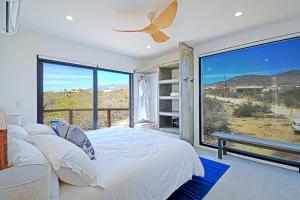 a bedroom with a bed and a large window at 20-30 Knots- 5br4ba Game Night Villa Hot Tub in El Sargento +50 photos