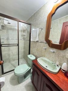 a bathroom with a toilet and a sink and a shower at Apartamento Edificio Parques Del Trianon in Envigado