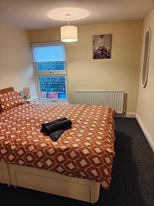 a bedroom with a bed and a window at The Warren in Skegness