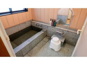 a bathroom with a tub and a sink and a mirror at Le Nessa Akazawa - Vacation STAY 16387v in Futo +40 photos