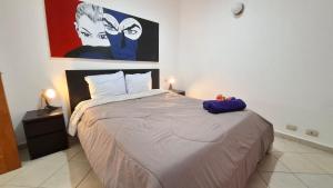 a bedroom with a bed and a painting on the wall at Tamarindo in Bayahibe +45 photos