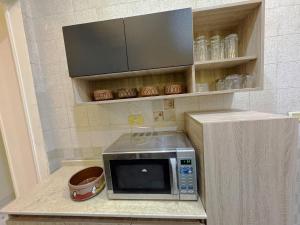 a microwave sitting on a counter in a kitchen at One-77 in Cairo