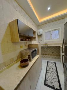 a small kitchen with a microwave on a counter at One-77 in Cairo +14 photos