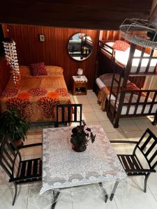 a bedroom with a bed and a table and chairs at Cabinas Lupita in Fortuna