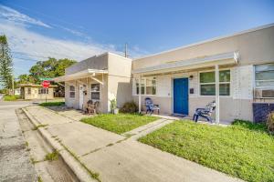 a white house with a blue door and a stop sign at Cozy Melbourne Hideaway Near Beaches, Downtown! in Melbourne