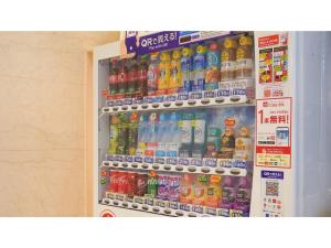 a refrigerator filled with lots of bottles of soda at The OneFive Osaka Namba Dotonbori - Vacation STAY 51549v in Osaka
