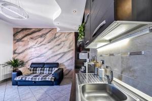 a kitchen with a sink and a couch at La Casa di Hellen 2room &living room 5pers app in Saronno +35 photos