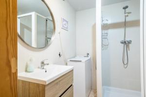a white bathroom with a sink and a mirror at Apartamento La Benasquita in Benasque